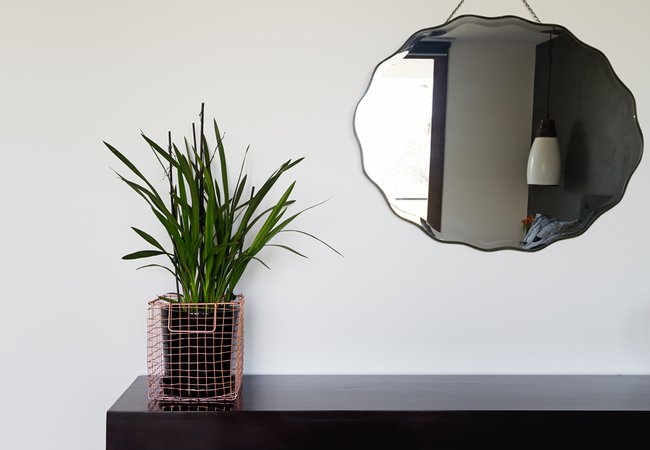 Home interior decor details copper wire basket and mirror in luxury bedroom